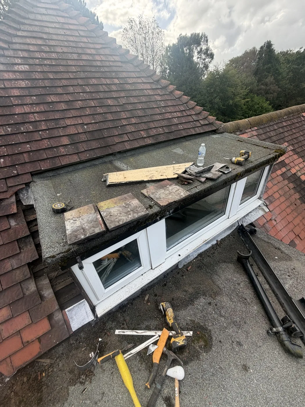 Earlier flat-roof covering and dormer junction at Ruff Lane