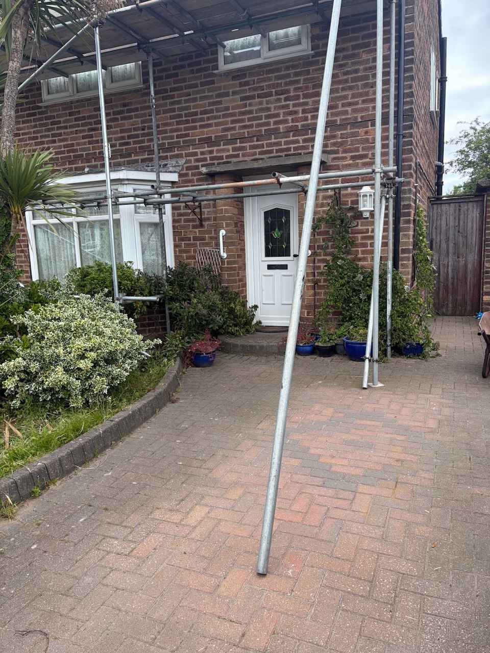 The property and scaffold during the roofing project