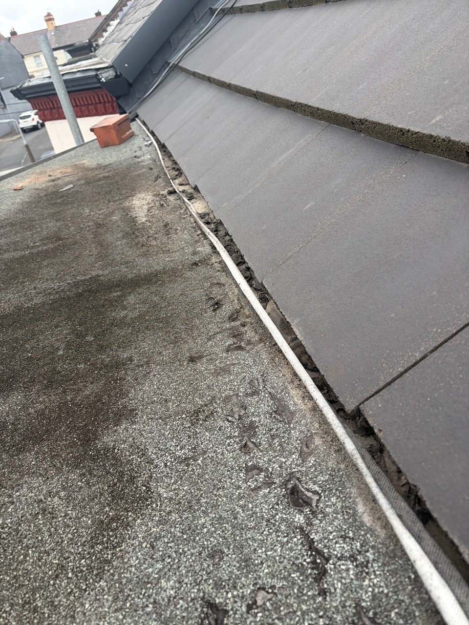 Old bay window flat roof and its junction with the tiled roof before replacement on Harradon Road in Fazakerley