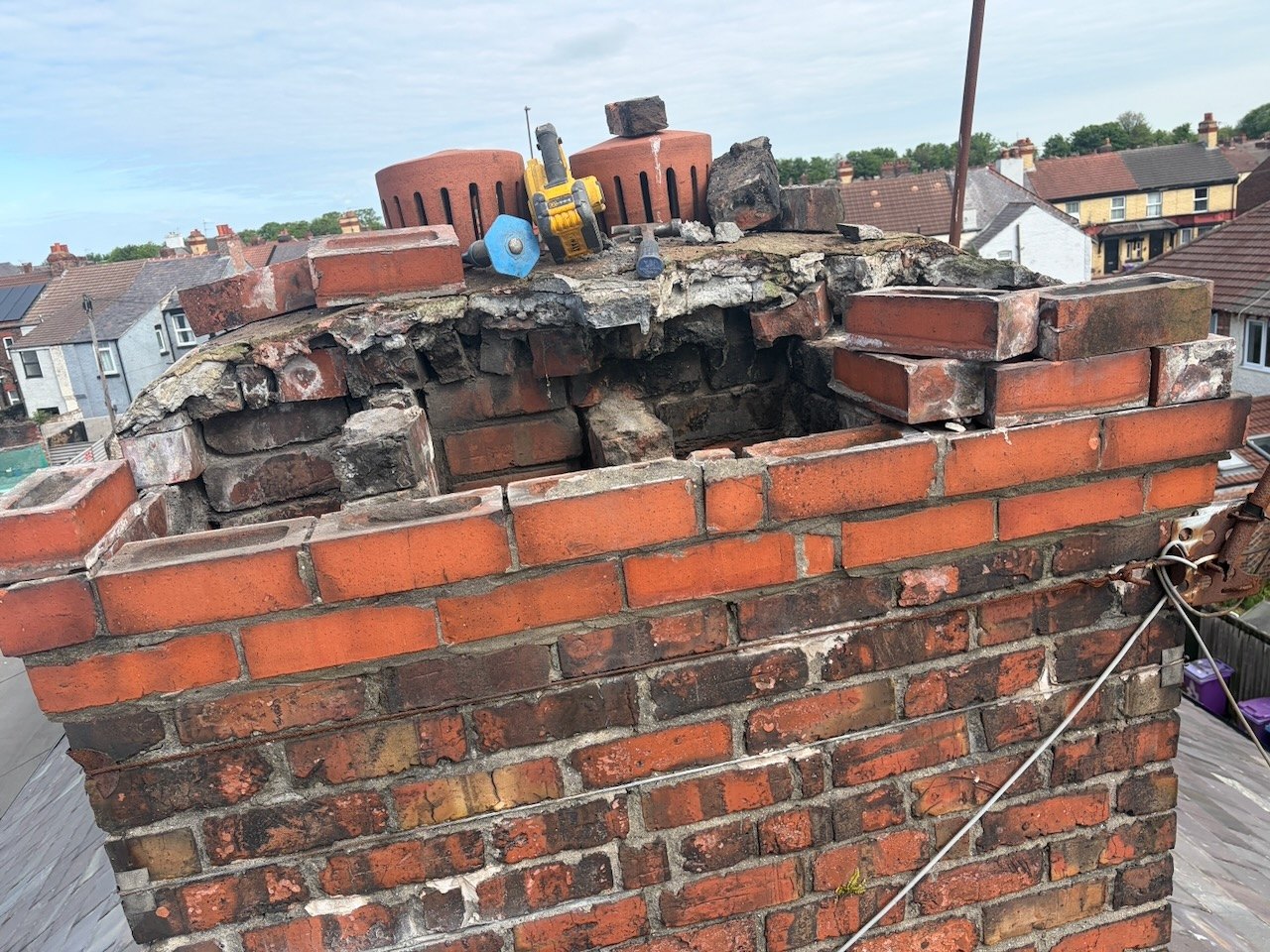 Upper chimney brickwork exposed during repairs and pot removal at the Fazakerley roofing project